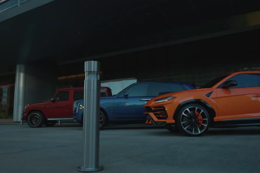 A Lamborghini Urus in a lineup under a canopy